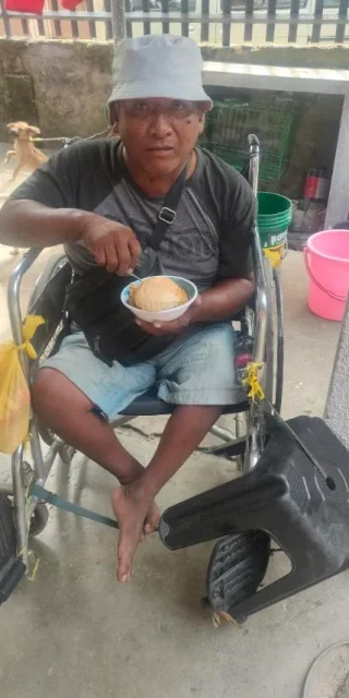 A sponsored wheelchair being presented to its recipient